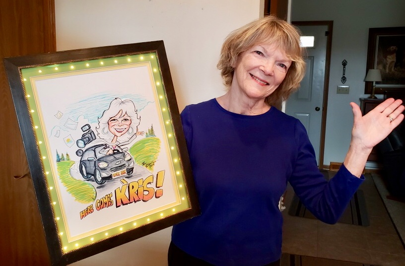 Women holding caricature drawn by Rex